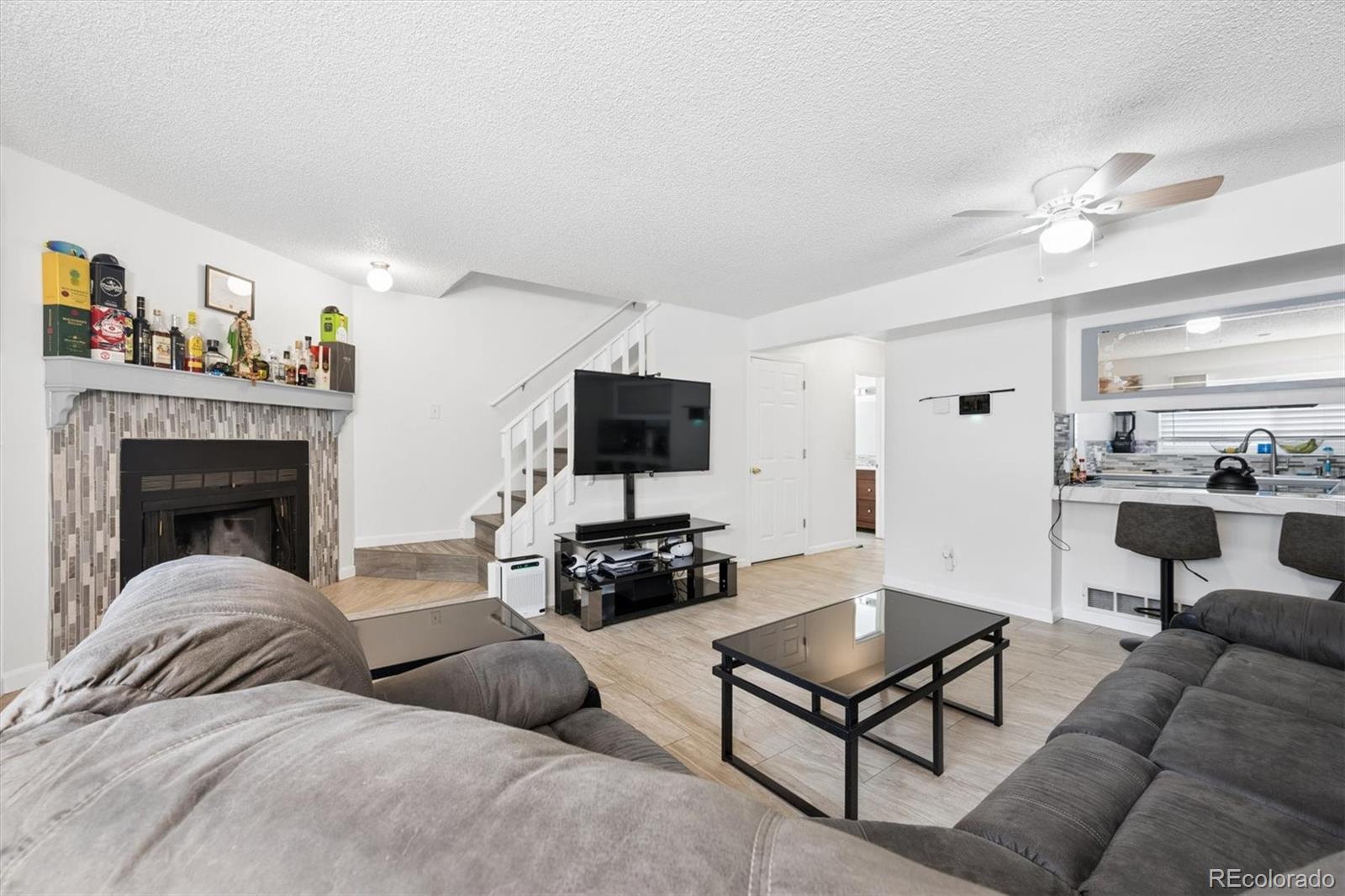11688 East Cedar Avenue Aurora, CO 80012 - Photo 4 of 24 a living room with furniture and a flat screen tv