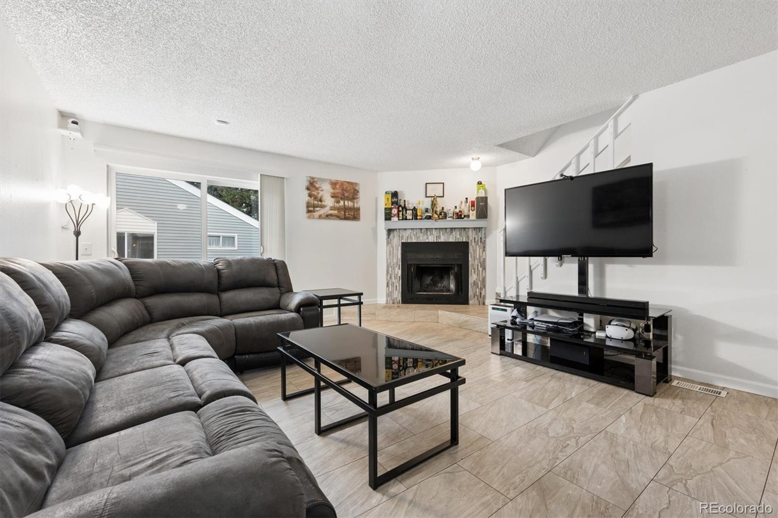 11688 East Cedar Avenue Aurora, CO 80012 - Photo 5 of 24 a living room with furniture and a flat screen tv
