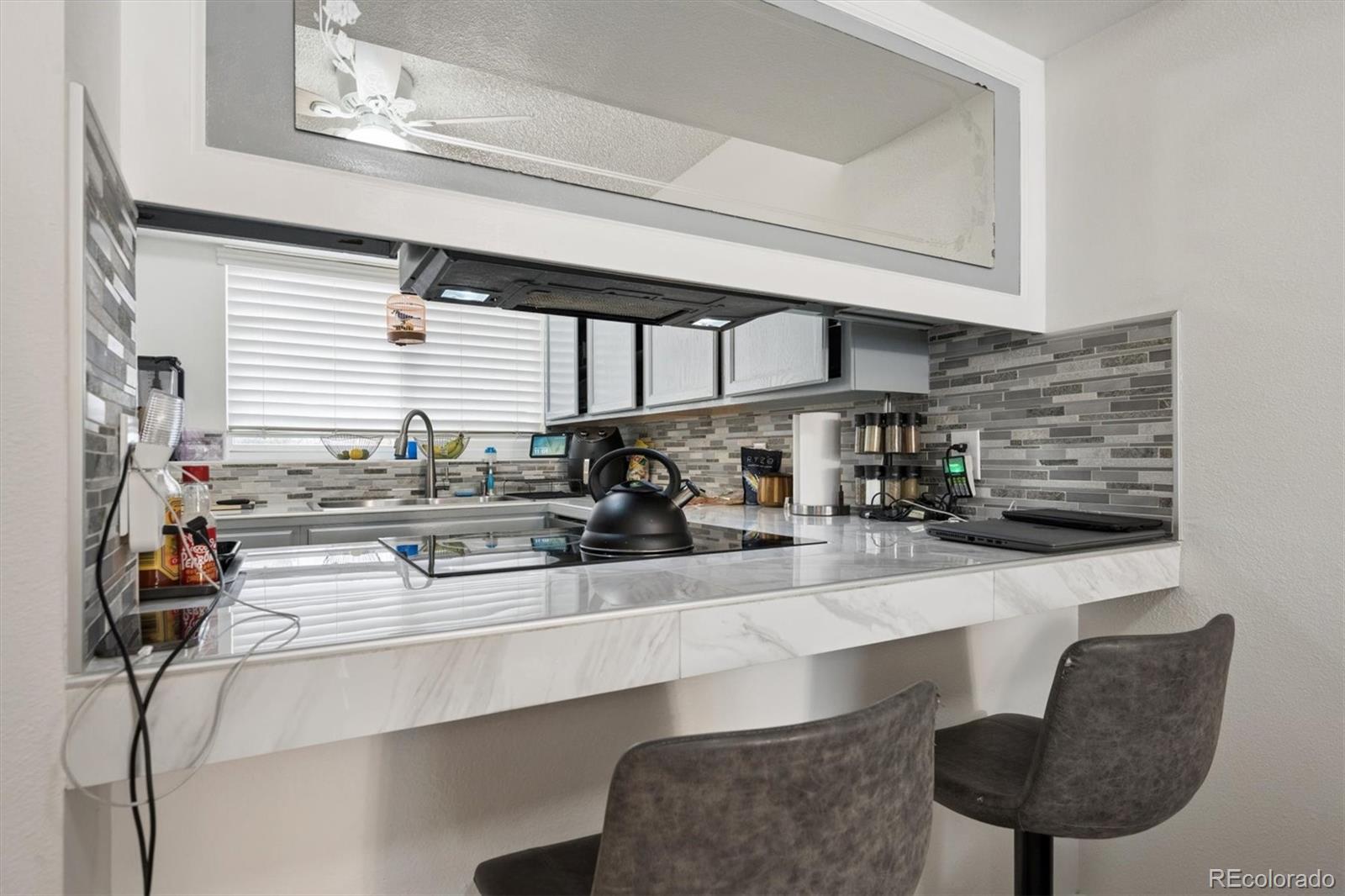 11688 East Cedar Avenue Aurora, CO 80012 - Photo 6 of 24 a kitchen with stainless steel appliances a sink and cabinets