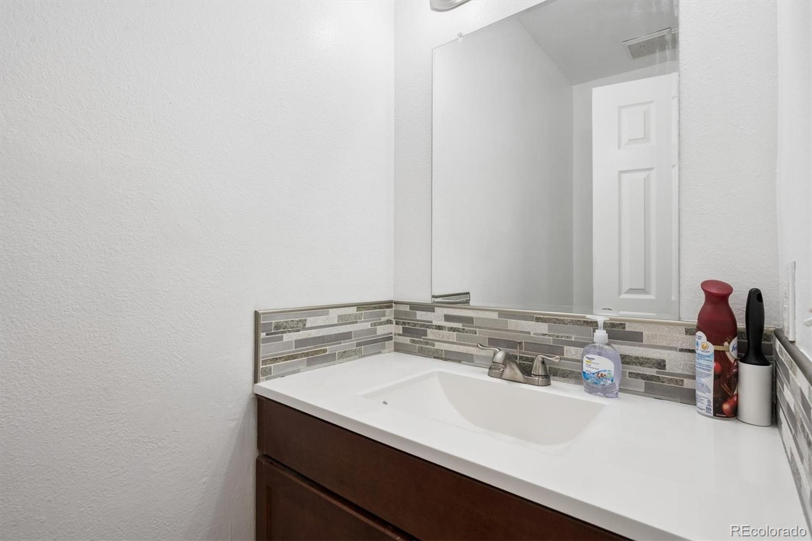 11688 East Cedar Avenue Aurora, CO 80012 - Photo 9 of 24 a bathroom with a sink and a mirror