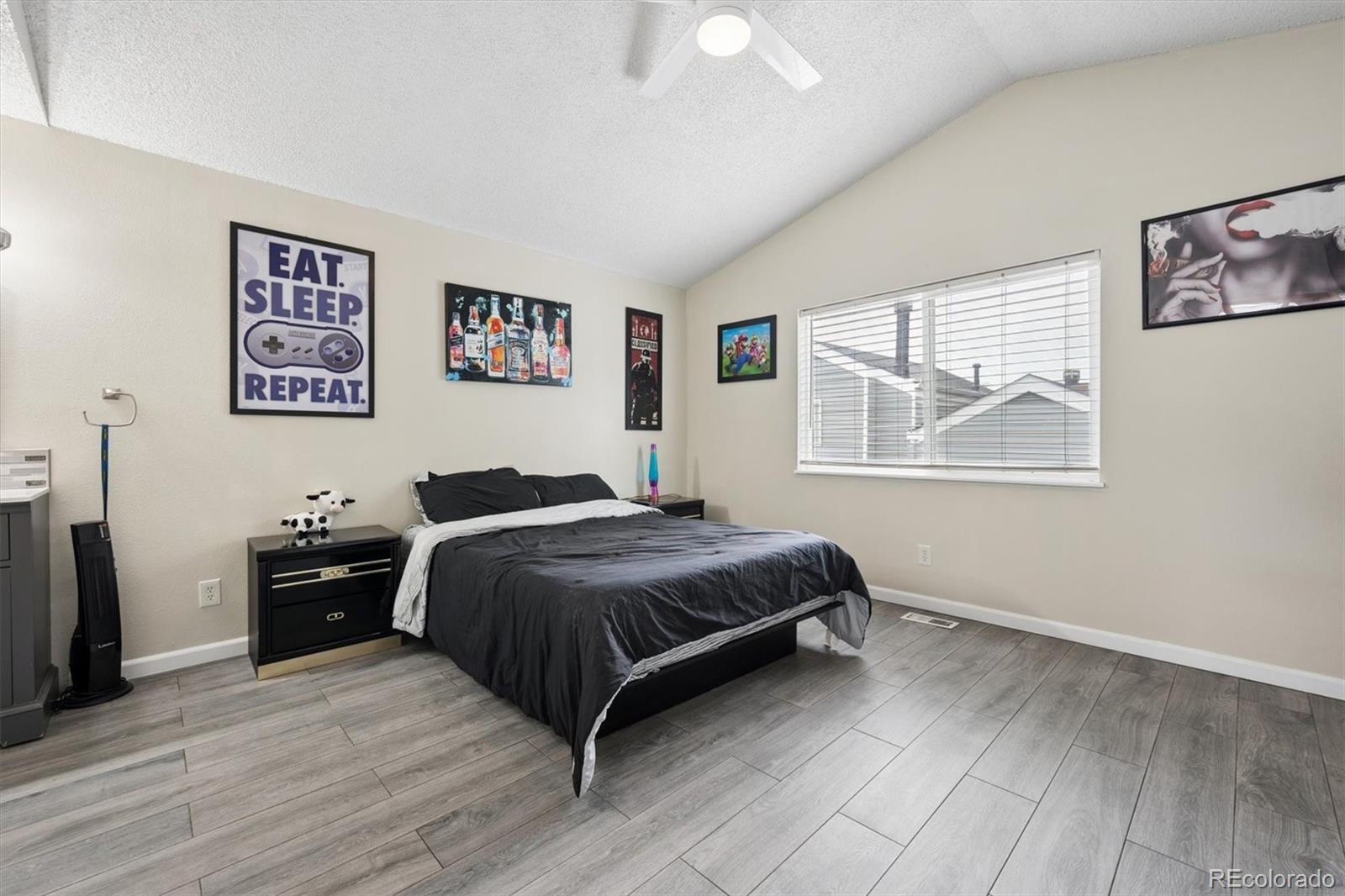 11688 East Cedar Avenue Aurora, CO 80012 - Photo 10 of 24 a bedroom with a bed and wooden floor