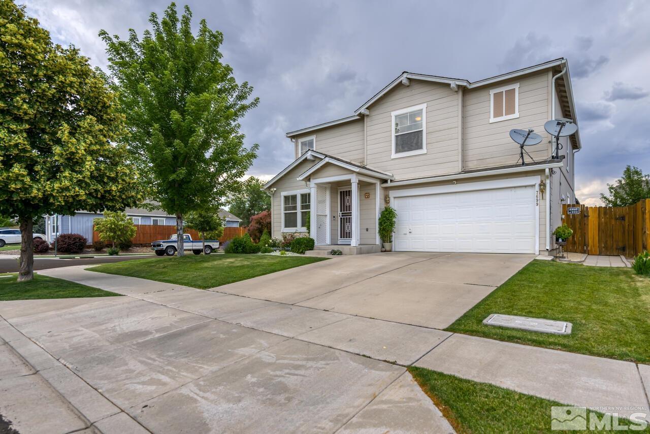 a front view of a house with a yard and garage