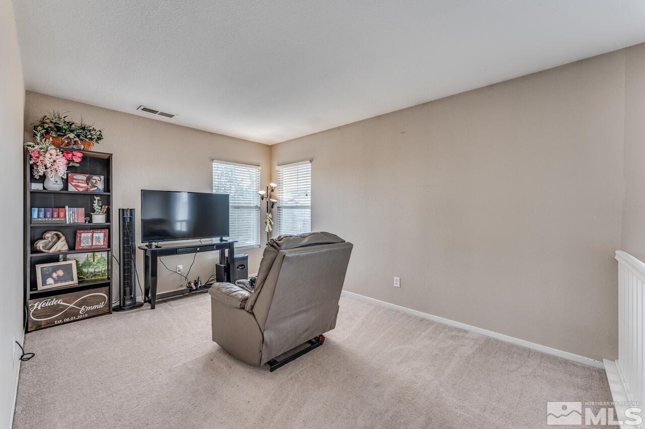 7699 Corso Street Reno, NV 89506 - Photo 28 of 36 a living room with furniture and a flat screen tv