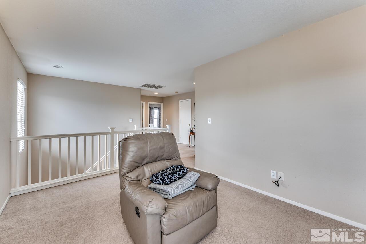 7699 Corso Street Reno, NV 89506 - Photo 29 of 36 a living room with furniture and a window