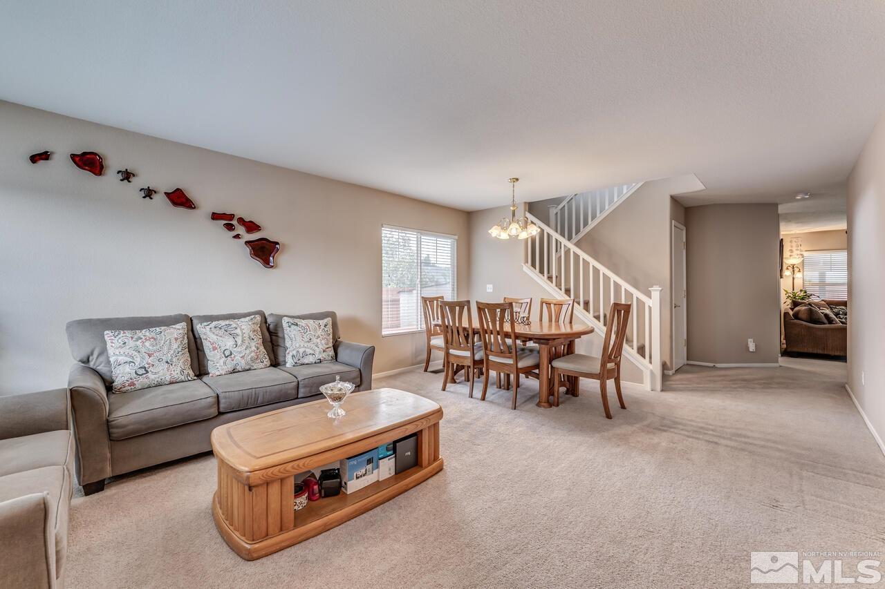 7699 Corso Street Reno, NV 89506 - Photo 3 of 36 a living room with furniture and a chandelier