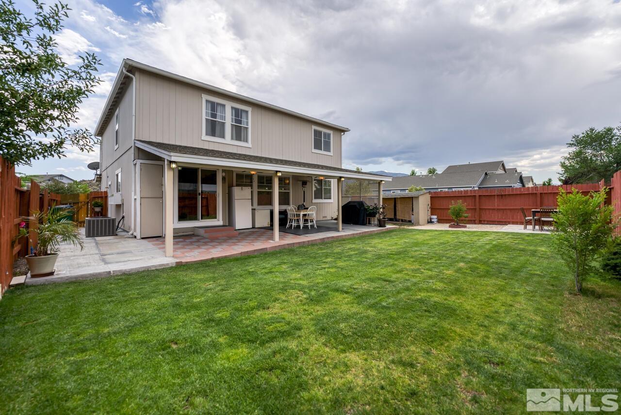 7699 Corso Street Reno, NV 89506 - Photo 31 of 36 a front view of a house with a yard and trees