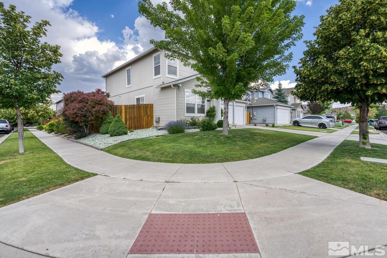7699 Corso Street Reno, NV 89506 - Photo 35 of 36 a view of a white house with a yard and potted plants