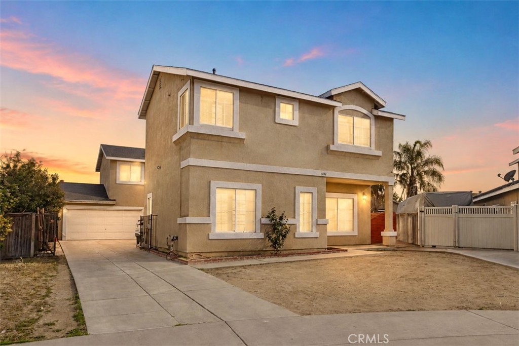 1494 Rabbit Peak Way Hemet, CA 92545 - Photo 2 of 45 a view of a house with a yard and garage