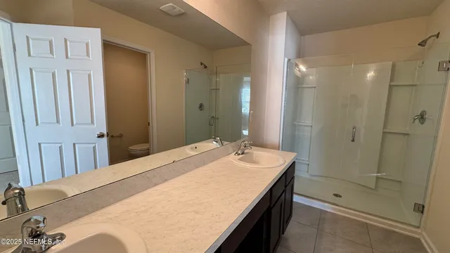 a spacious bathroom with a shower and a sink