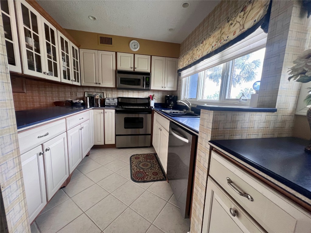 95116 Sandpiper Loop Fernandina Beach, FL 32034 - Photo 12 of 40 a kitchen with stainless steel appliances a stove a sink and a microwave