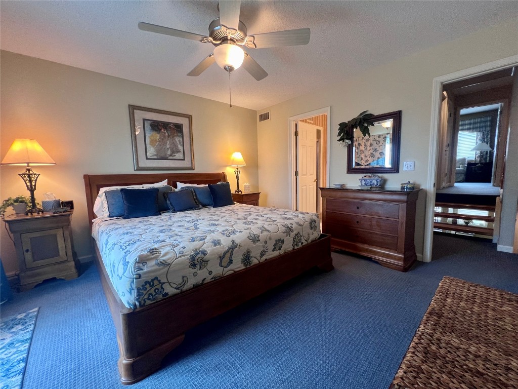 95116 Sandpiper Loop Fernandina Beach, FL 32034 - Photo 15 of 40 a bedroom with a large bed and a chandelier