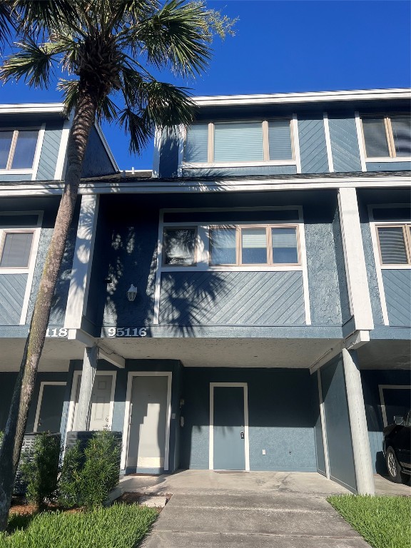 95116 Sandpiper Loop Fernandina Beach, FL 32034 - Photo 2 of 40 a view of building with a lot of windows and plants