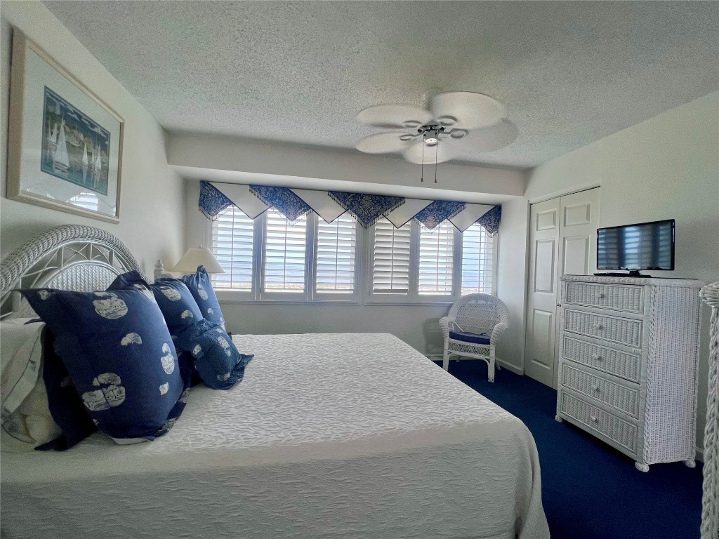 95116 Sandpiper Loop Fernandina Beach, FL 32034 - Photo 26 of 40 a bedroom with a bed mirror on dresser and a window