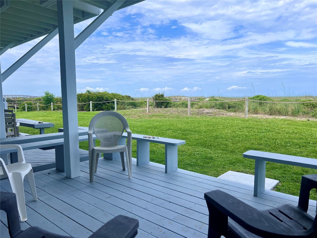 95116 Sandpiper Loop Fernandina Beach, FL 32034 - Photo 6 of 40 a view of a deck with table and chairs and wooden floor with a yard