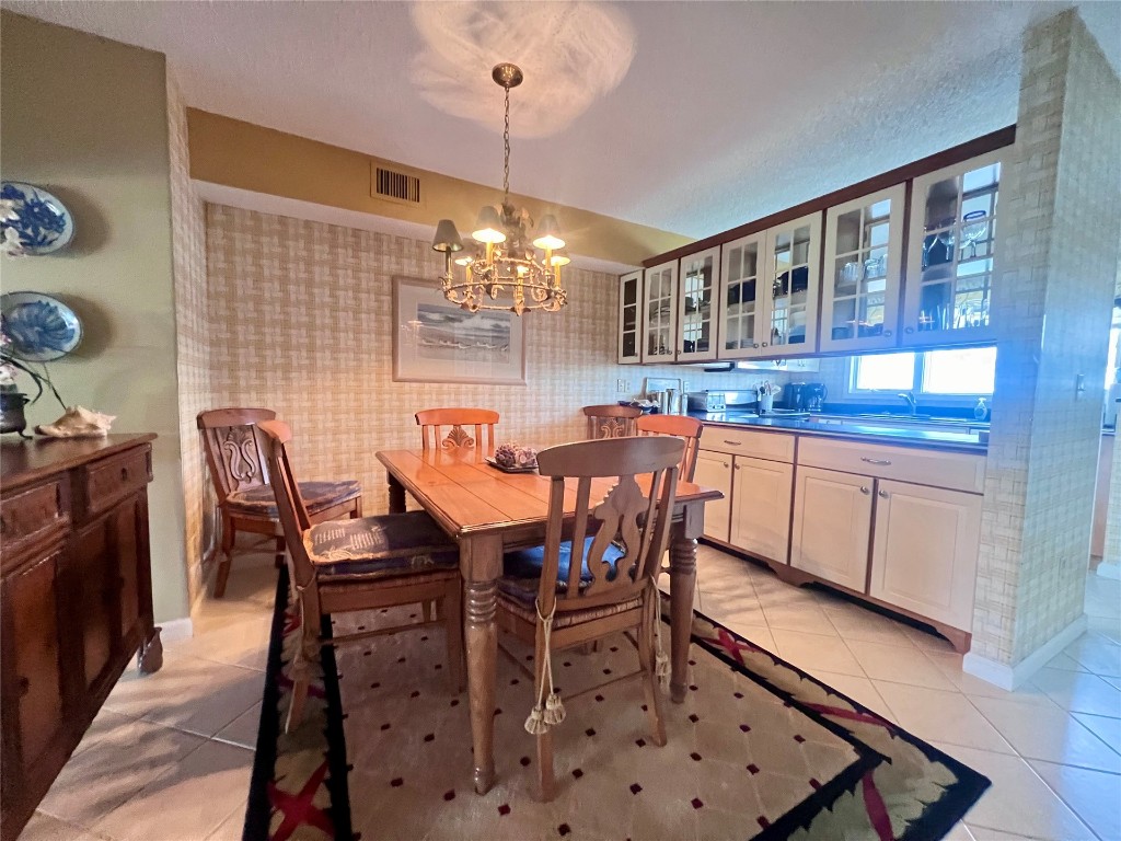 95116 Sandpiper Loop Fernandina Beach, FL 32034 - Photo 9 of 40 a dining room with furniture a chandelier and wooden floor