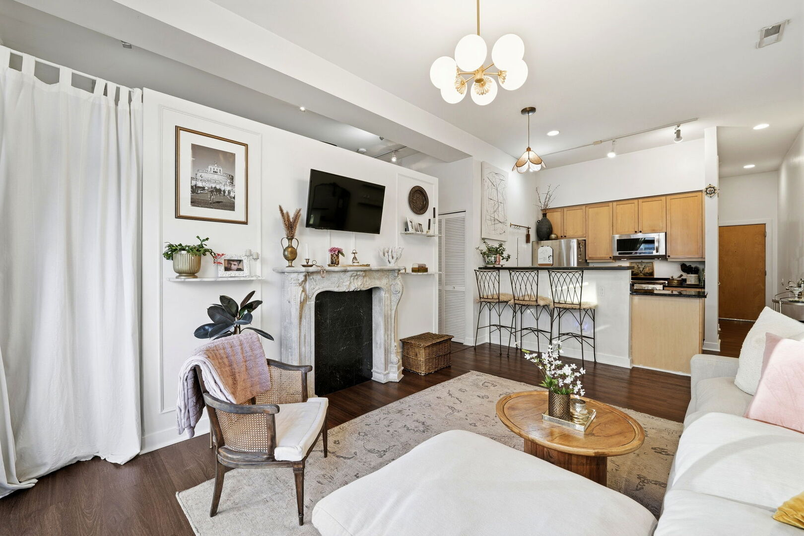 949 West Madison Street, Unit 304 Chicago, IL 60607 - Photo 5 of 21 a living room with furniture a fireplace and a flat screen tv