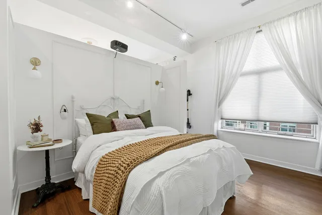 a bedroom with a bed and a window