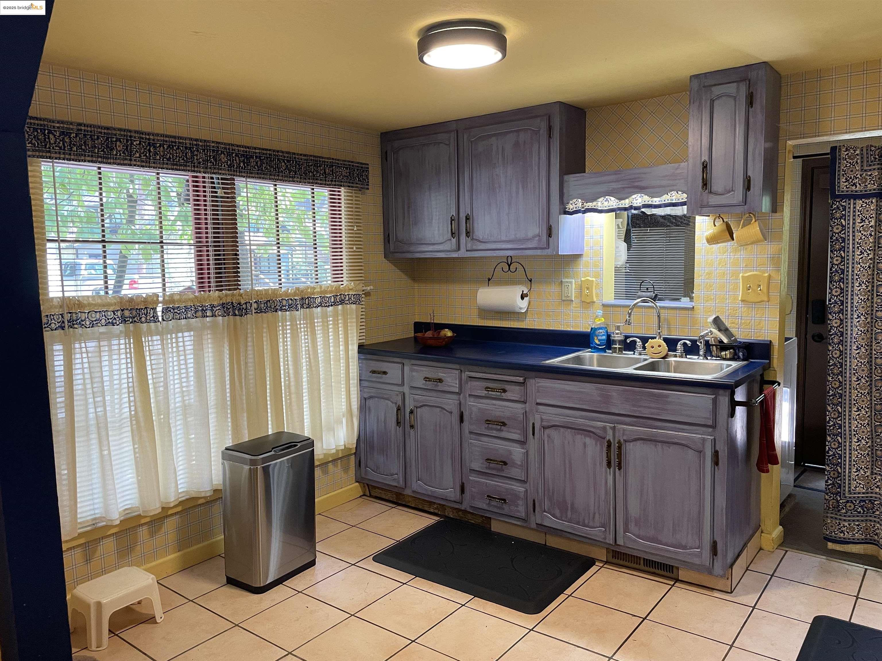22846 Fuller Road Twain Harte, CA 95383 - Photo 11 of 40 Kitchen featuring dark countertops, light tile patterned flooring, and backsplash