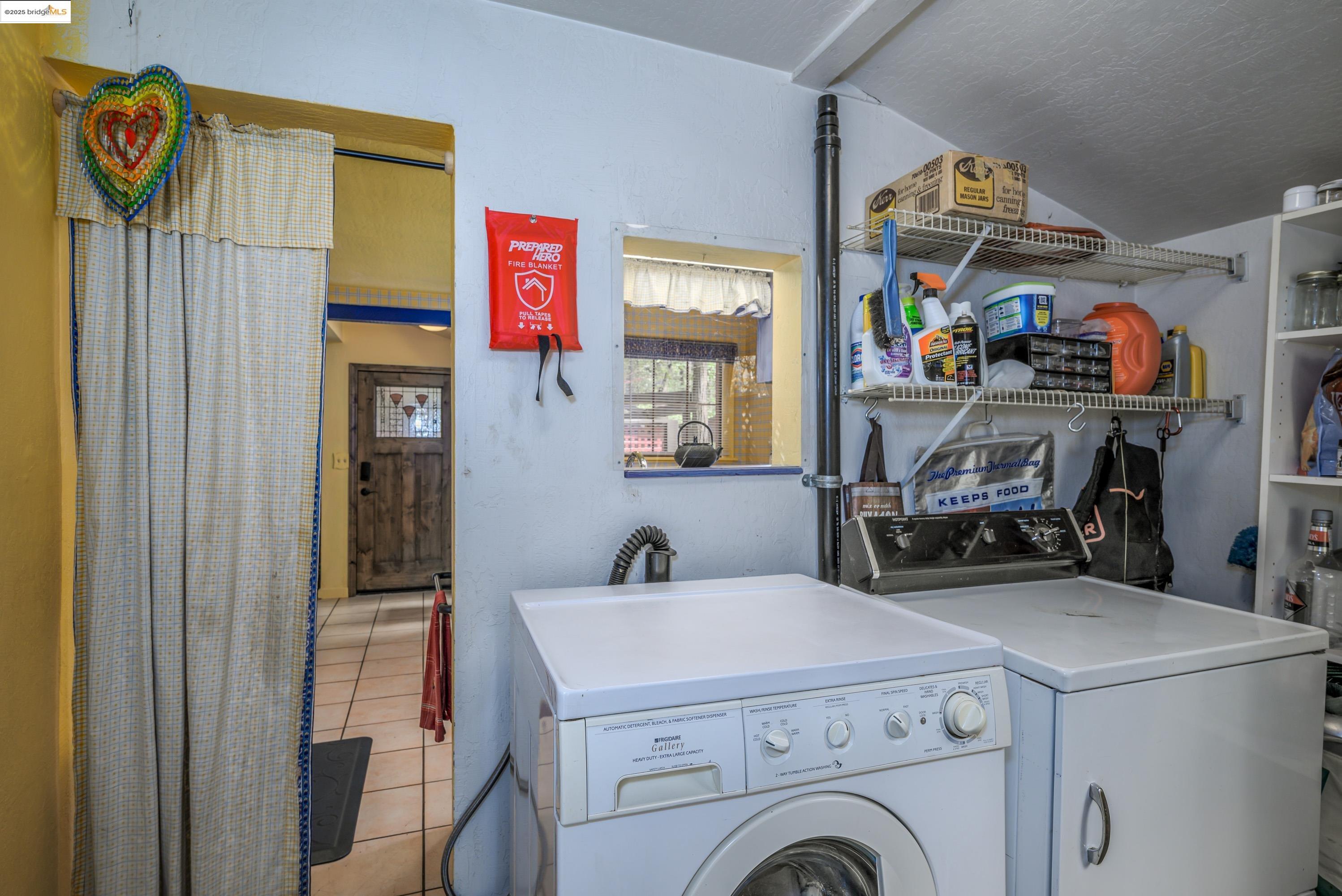 22846 Fuller Road Twain Harte, CA 95383 - Photo 13 of 40 Laundry room featuring light tile patterned flooring and separate washer and dryer
