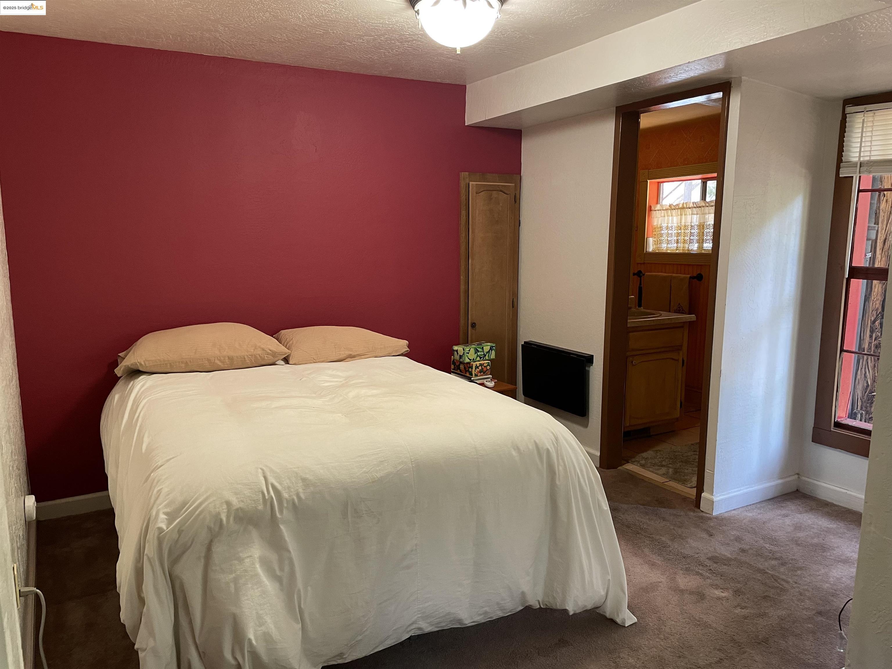 22846 Fuller Road Twain Harte, CA 95383 - Photo 14 of 40 Carpeted bedroom with a textured ceiling and connected bathroom