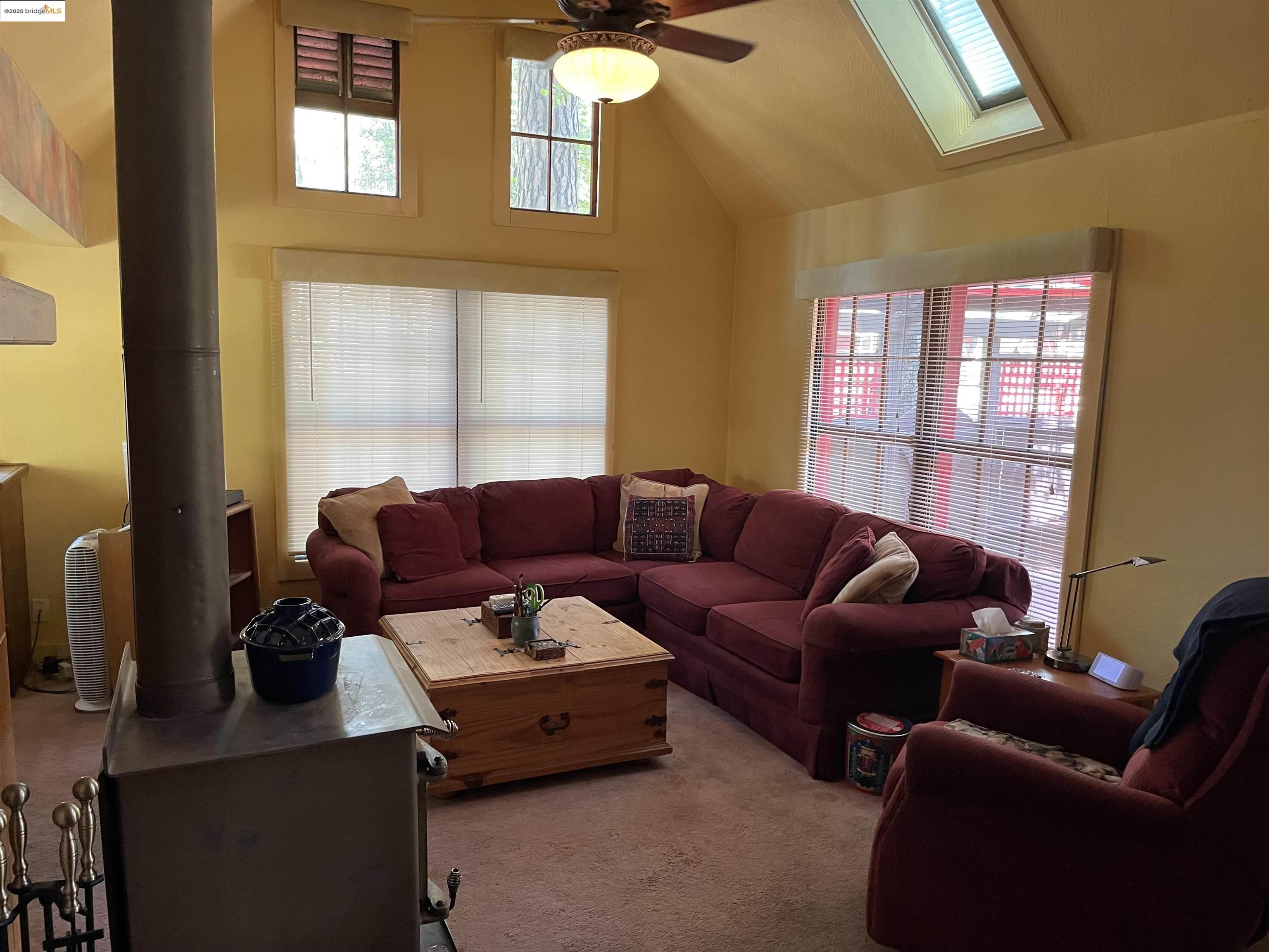22846 Fuller Road Twain Harte, CA 95383 - Photo 6 of 40 Carpeted living room with a skylight, lofted ceiling, and ceiling fan