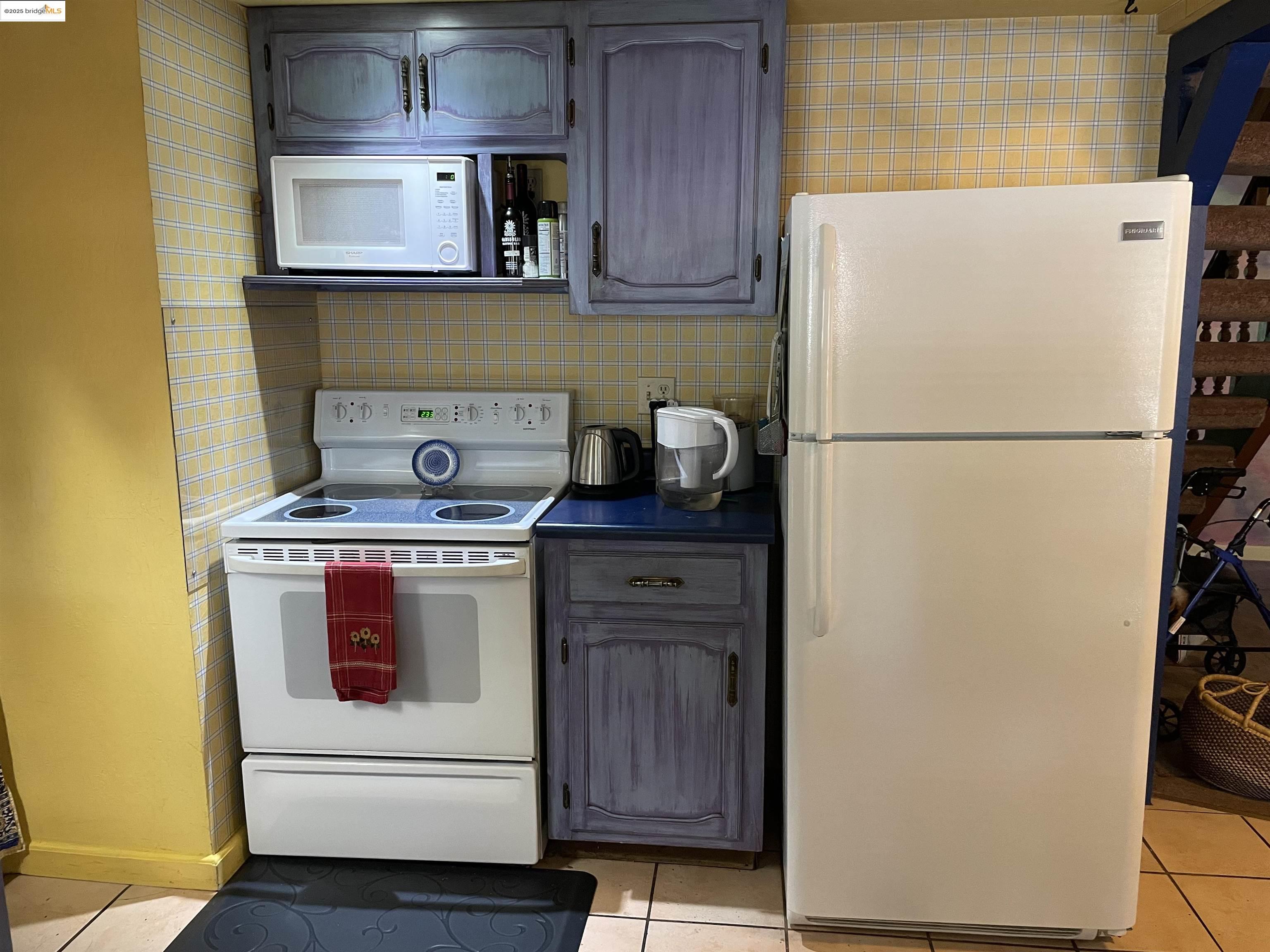 22846 Fuller Road Twain Harte, CA 95383 - Photo 10 of 40 Kitchen with white appliances, light tile patterned flooring, and dark countertops