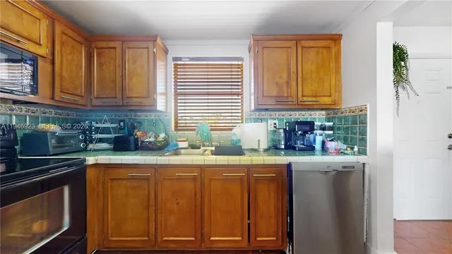 a bathroom with a granite countertop toilet and sink