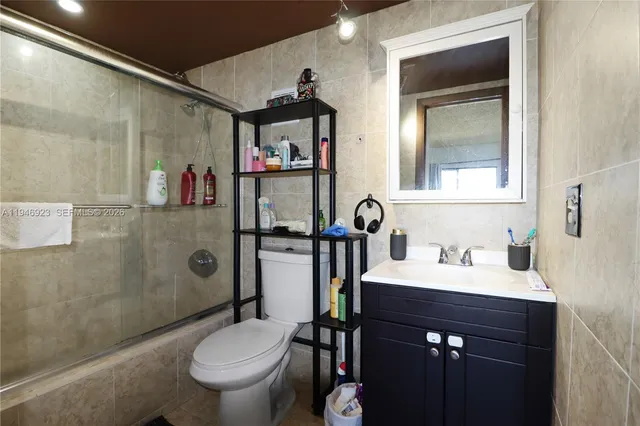 a bathroom with a toilet a sink and shower