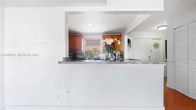 a kitchen with granite countertop a sink stainless steel appliances a counter top space and cabinets