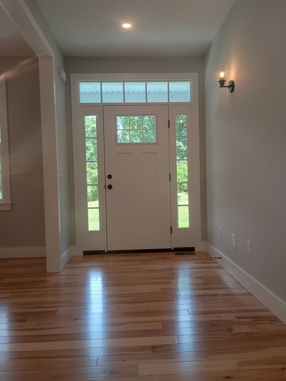 73 Depot Road Leverett, MA 01054 - Photo 18 of 39 a view of an empty room with wooden floor and a window
