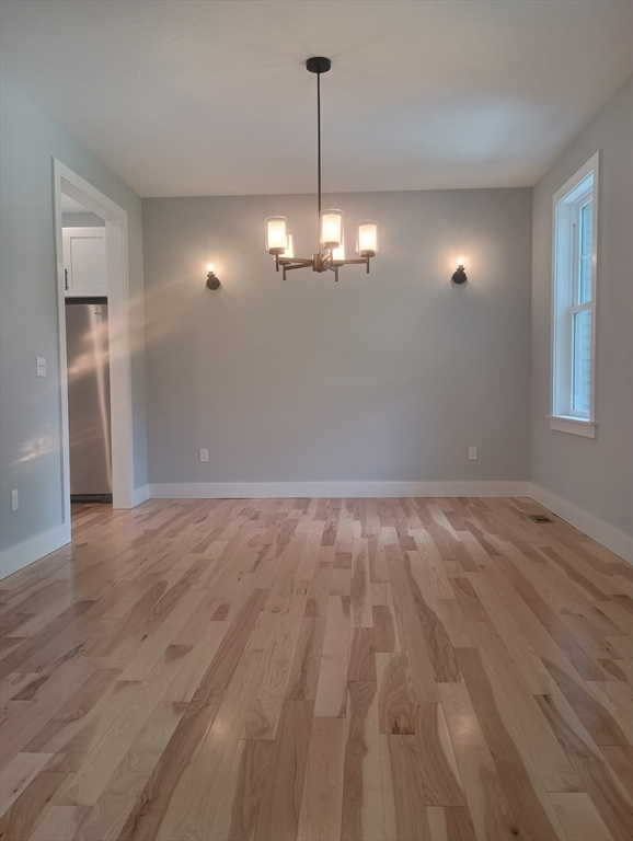73 Depot Road Leverett, MA 01054 - Photo 19 of 39 a view of a room with wooden floor chandelier and window