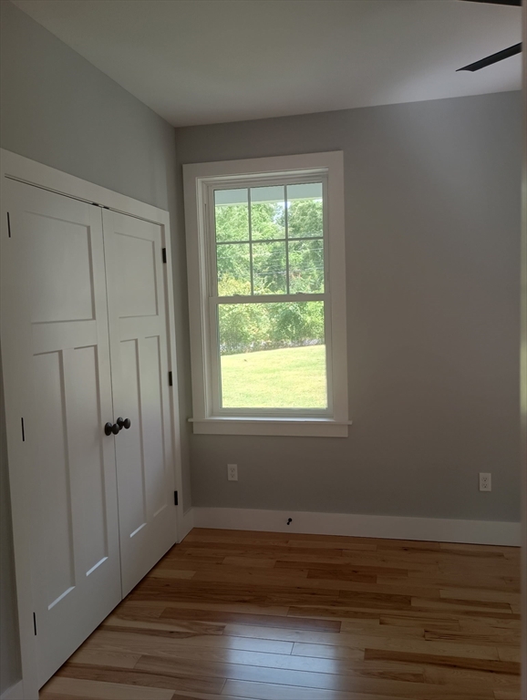 73 Depot Road Leverett, MA 01054 - Photo 22 of 39 a view of an empty room with wooden floor and a window