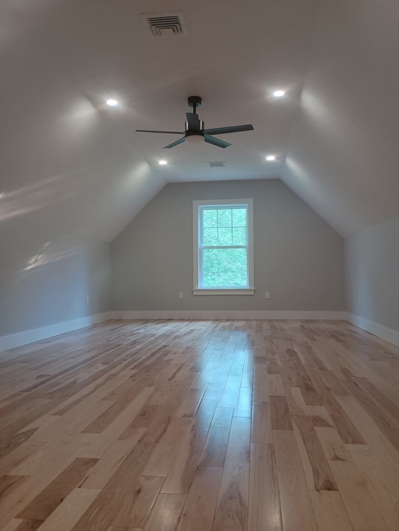 73 Depot Road Leverett, MA 01054 - Photo 33 of 39 an empty room with wooden floor ceiling fan and windows
