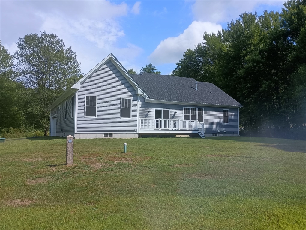 73 Depot Road Leverett, MA 01054 - Photo 7 of 39 a view of a yard in front of a house with plants and large tree