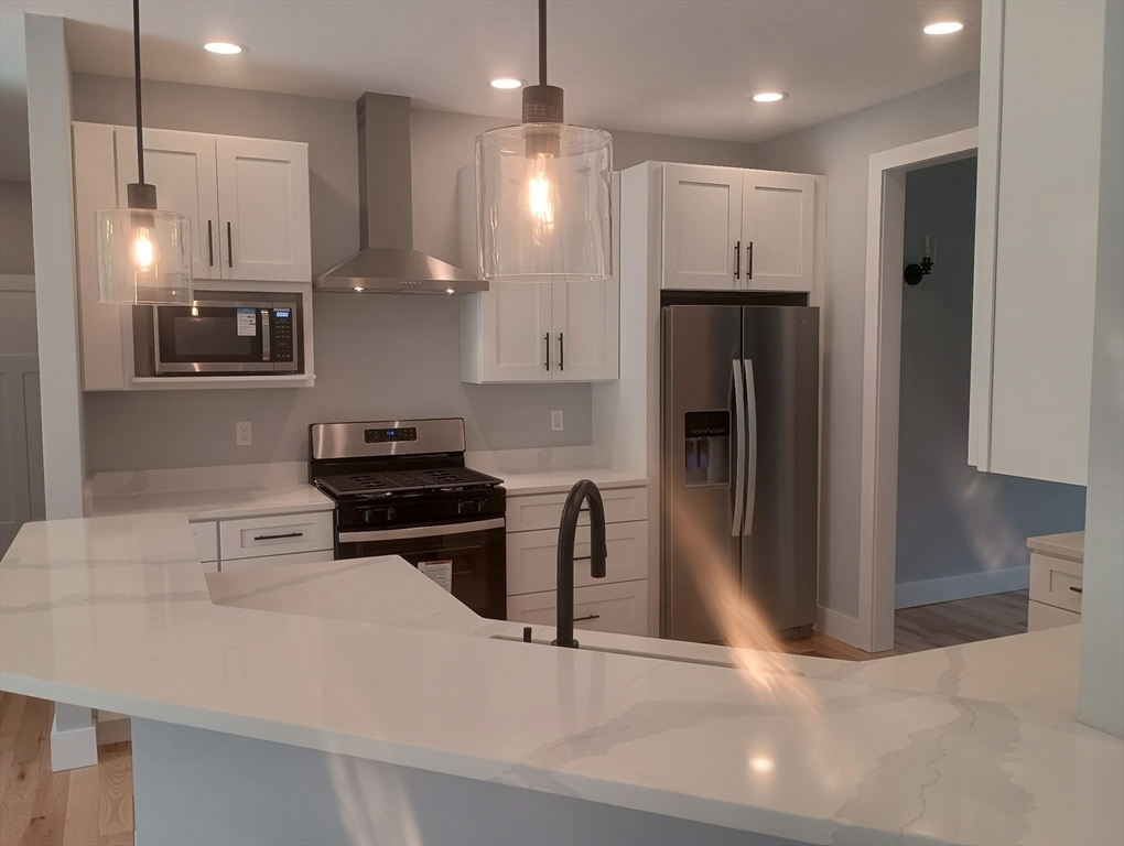 73 Depot Road Leverett, MA 01054 - Photo 10 of 39 a kitchen with stainless steel appliances granite countertop a refrigerator and a stove top oven