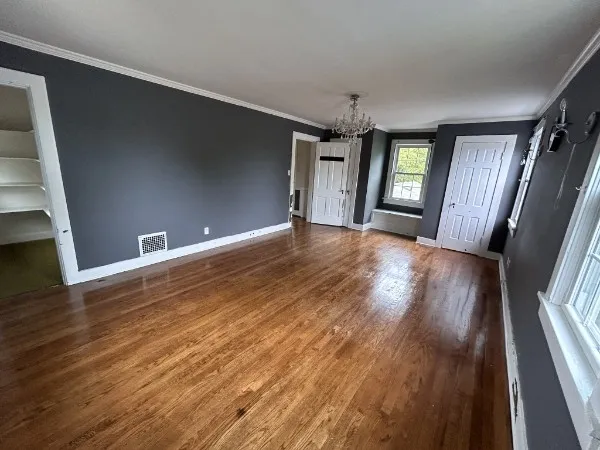 wooden floor in an empty room with a window