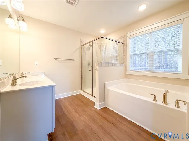 a bathroom with a tub sink and a mirror