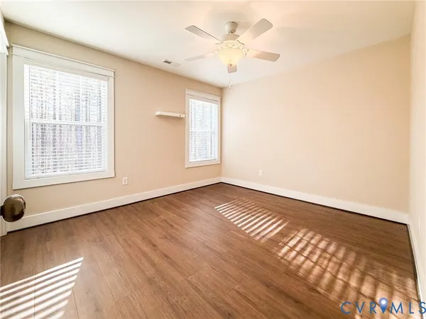 wooden floor in an empty room with a window