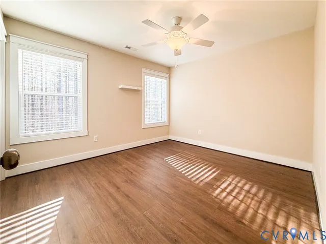 wooden floor in an empty room with a window