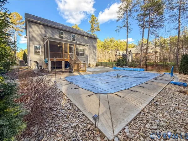 a view of a house with backyard porch and sitting area