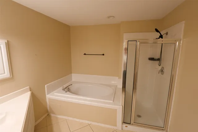 a white bath tub sitting next to a shower