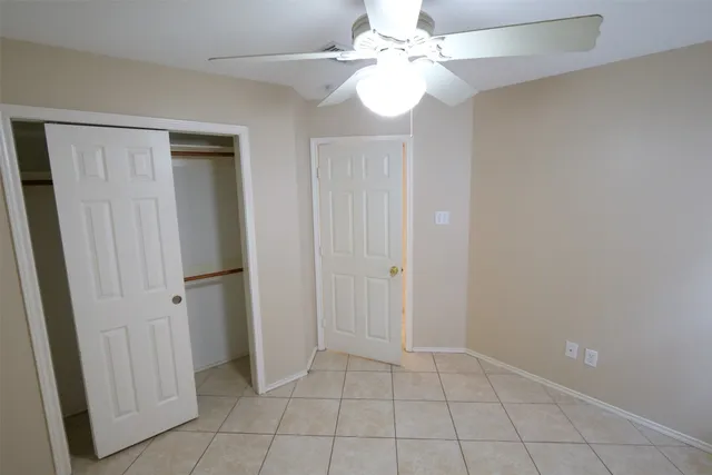 a view of an empty room with a fan