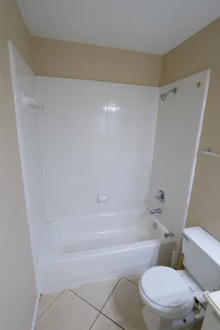 a bathroom with a toilet and a bath tub