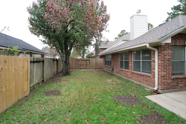 a view of house with backyard