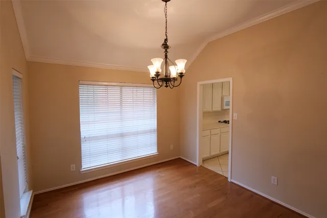 a view of a room with window and chandelier
