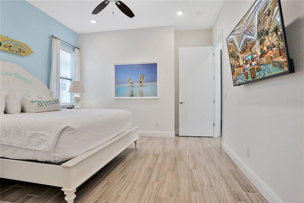 8038 Surf Street Kissimmee, FL 34747 - Photo 12 of 81 a bedroom with a bed and painting on the wall