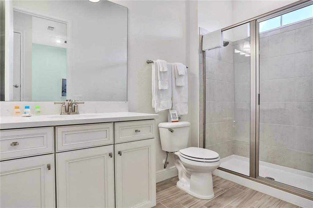 8038 Surf Street Kissimmee, FL 34747 - Photo 13 of 81 a bathroom with a sink toilet and shower