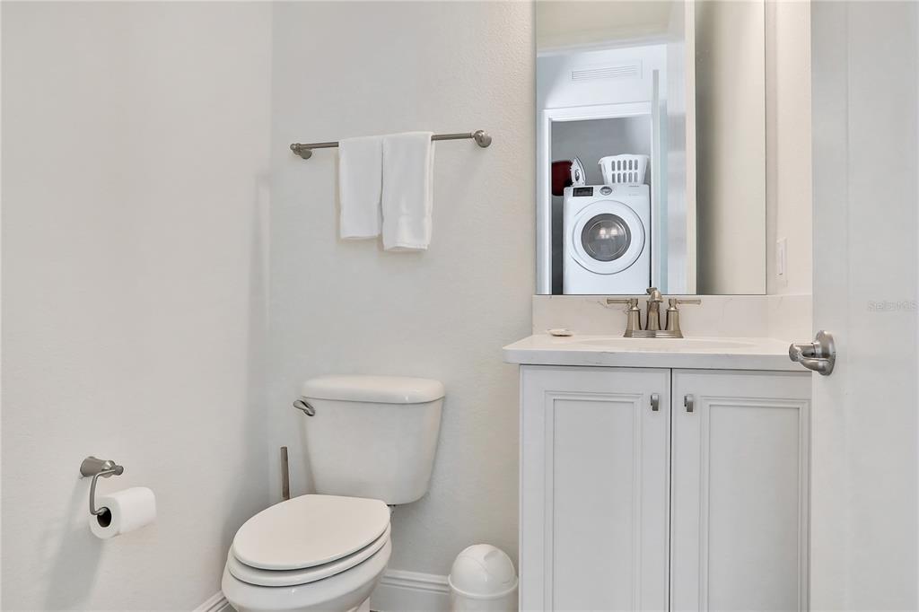 8038 Surf Street Kissimmee, FL 34747 - Photo 16 of 81 a bathroom with a toilet a sink and mirror