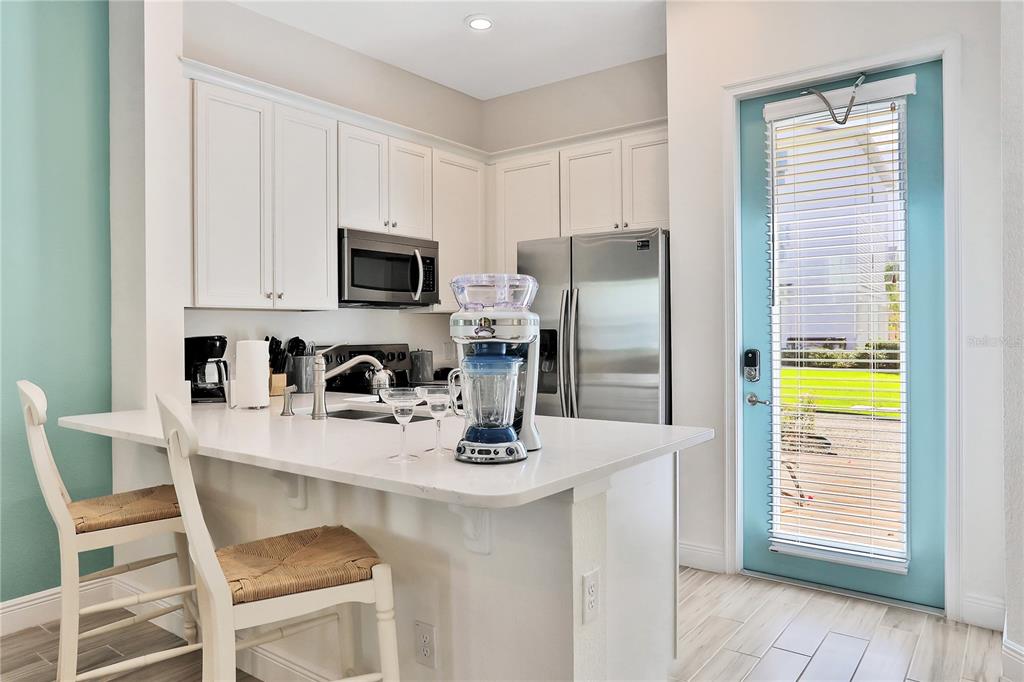8038 Surf Street Kissimmee, FL 34747 - Photo 6 of 81 a kitchen with a refrigerator and a stove top oven