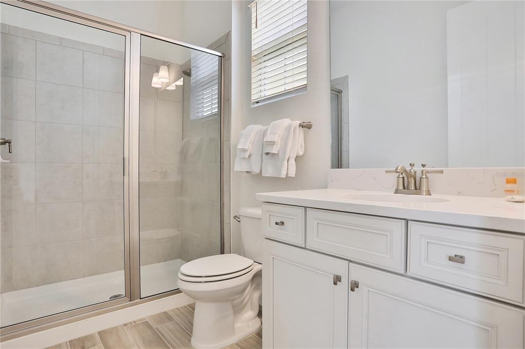 8038 Surf Street Kissimmee, FL 34747 - Photo 10 of 81 a bathroom with a sink a toilet and shower